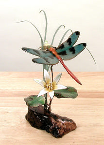 Orange tailed dragonfly with flower